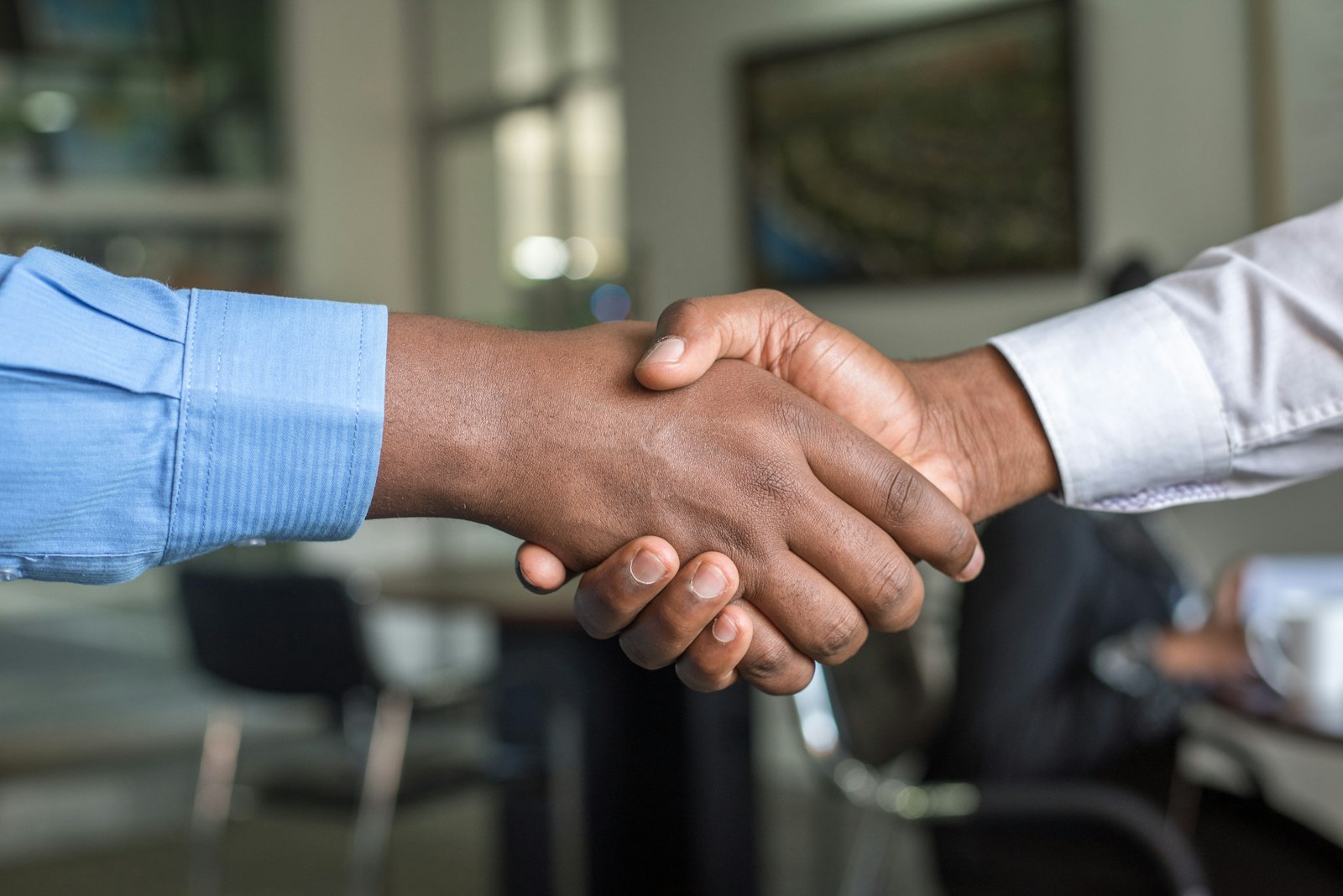 Two business people shaking hands after agreeing on a project