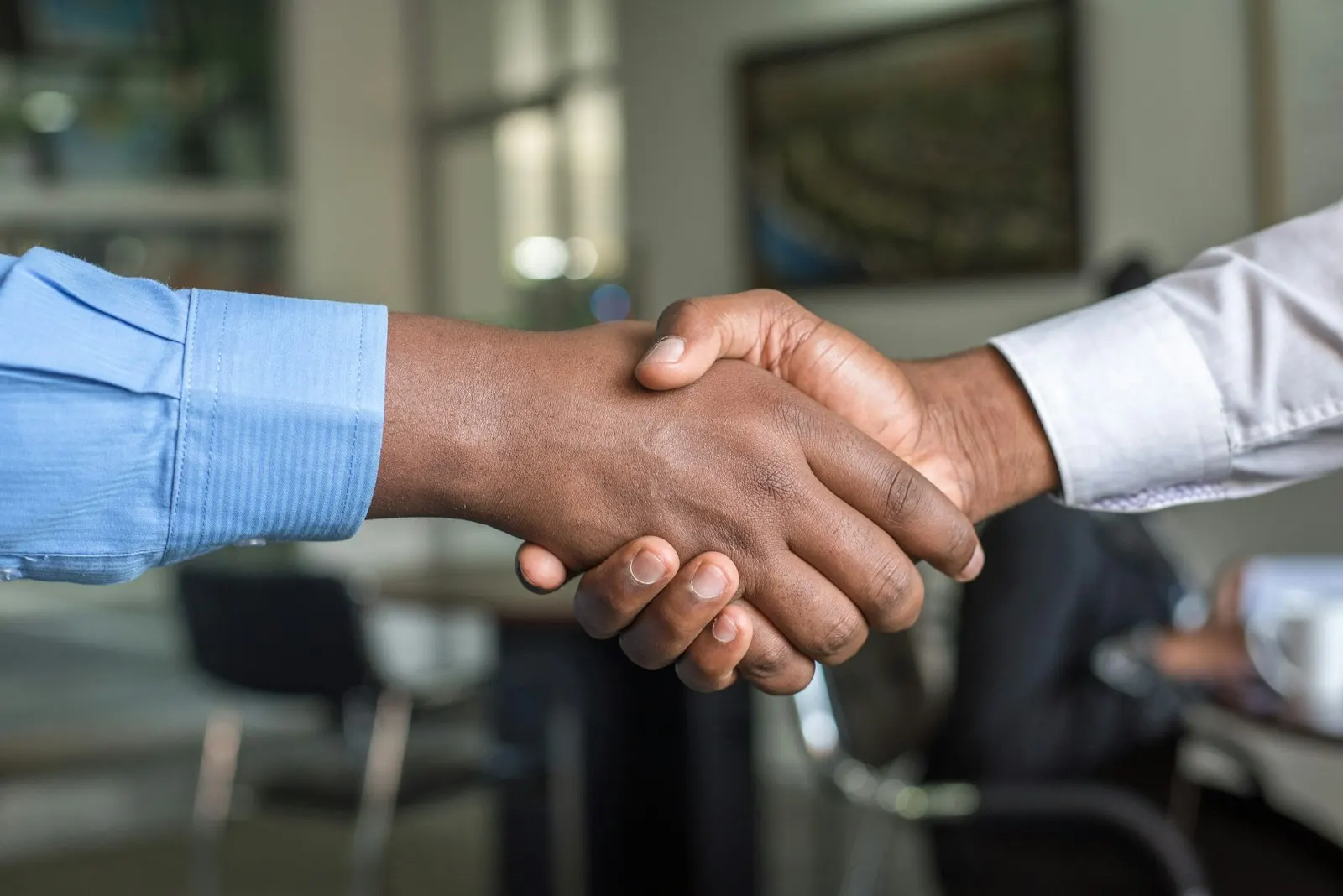 Two business people shaking hands after agreeing on a project